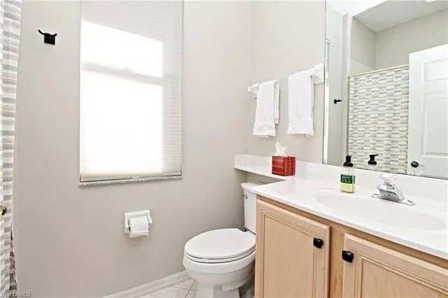 a patio with table and chairs and potted plants