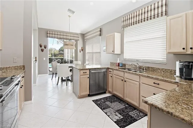 a kitchen with a sink stove and cabinets
