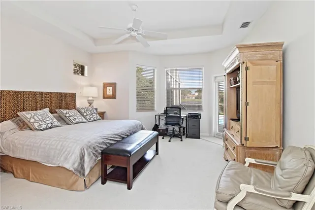 a bedroom with a bed couch and a window