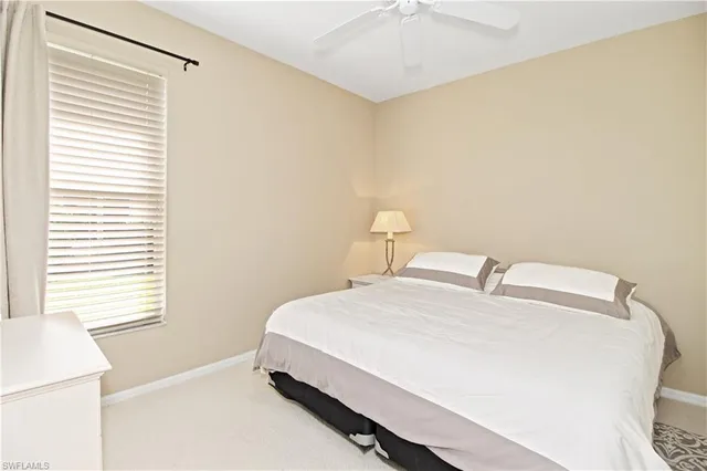 a bedroom with bed and window