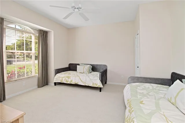 a view of a dining room with furniture and a chandelier