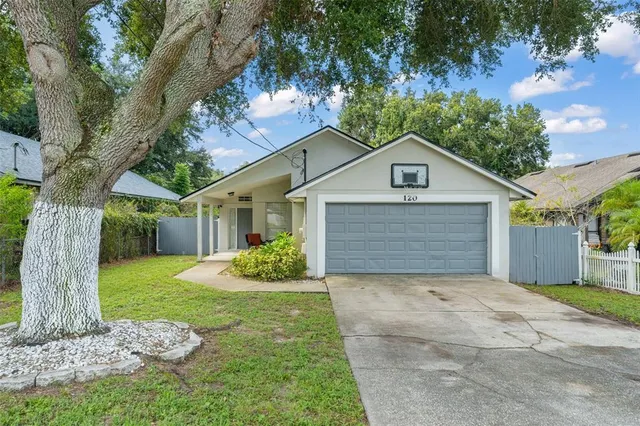 a front view of house with yard and green space