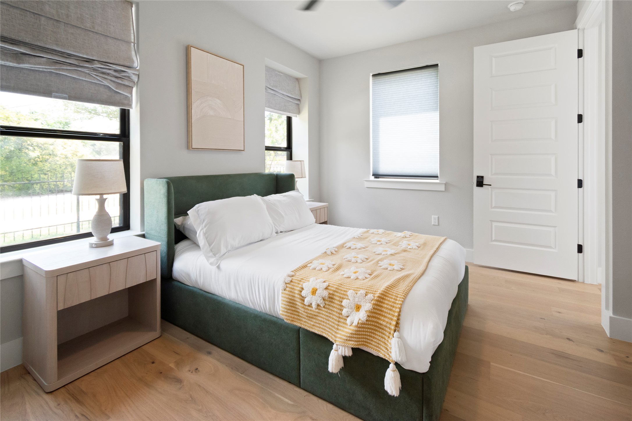 13309 Morris Road, Unit 62 Austin, TX 78729 - Photo 9 of 21 Well-lit sleeping quarters featuring light wood flooring and private outdoor views.