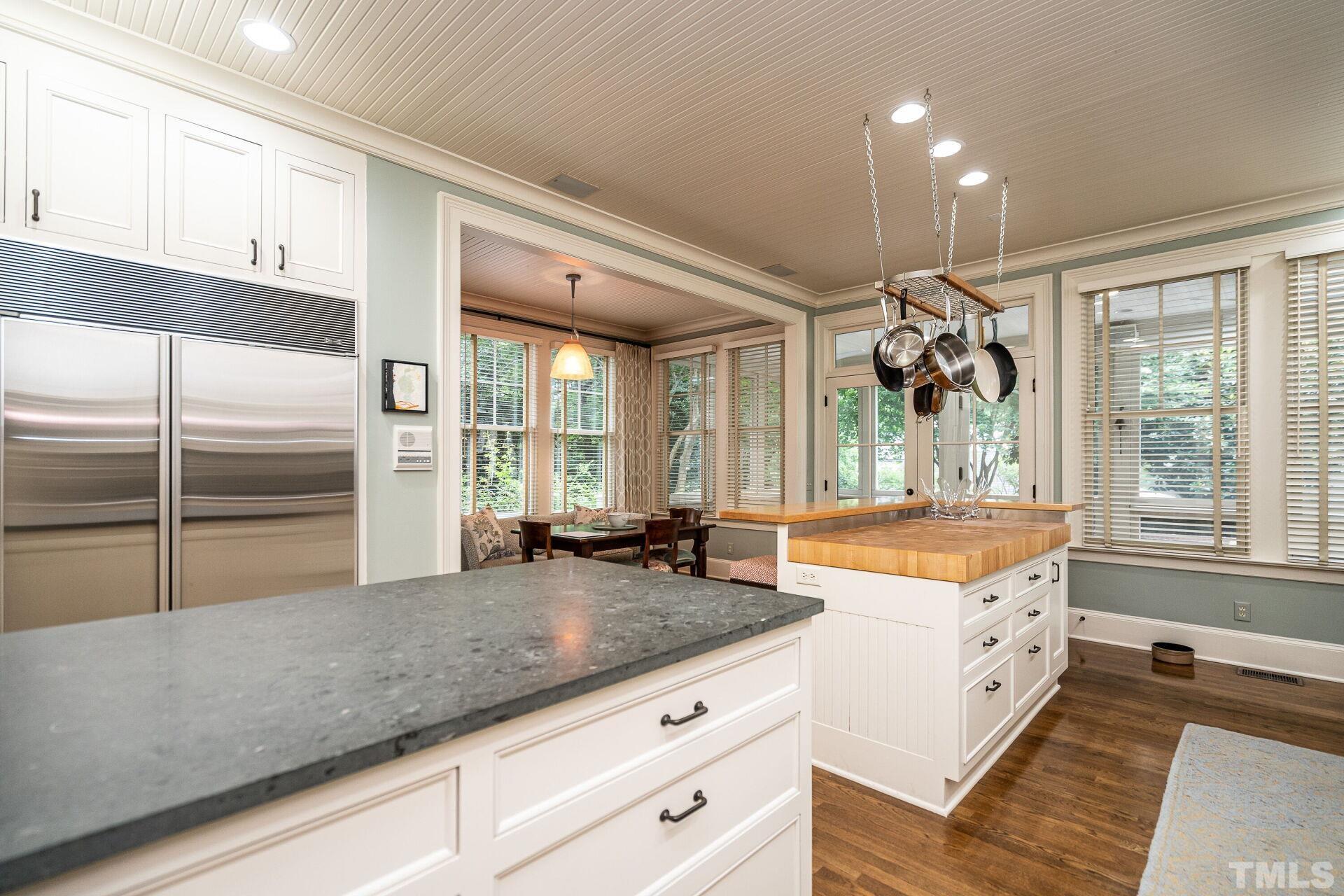 1027 Vance Street Raleigh, NC 27608 - Photo 18 of 42 a large kitchen with kitchen island granite countertop a large window and stainless steel appliances