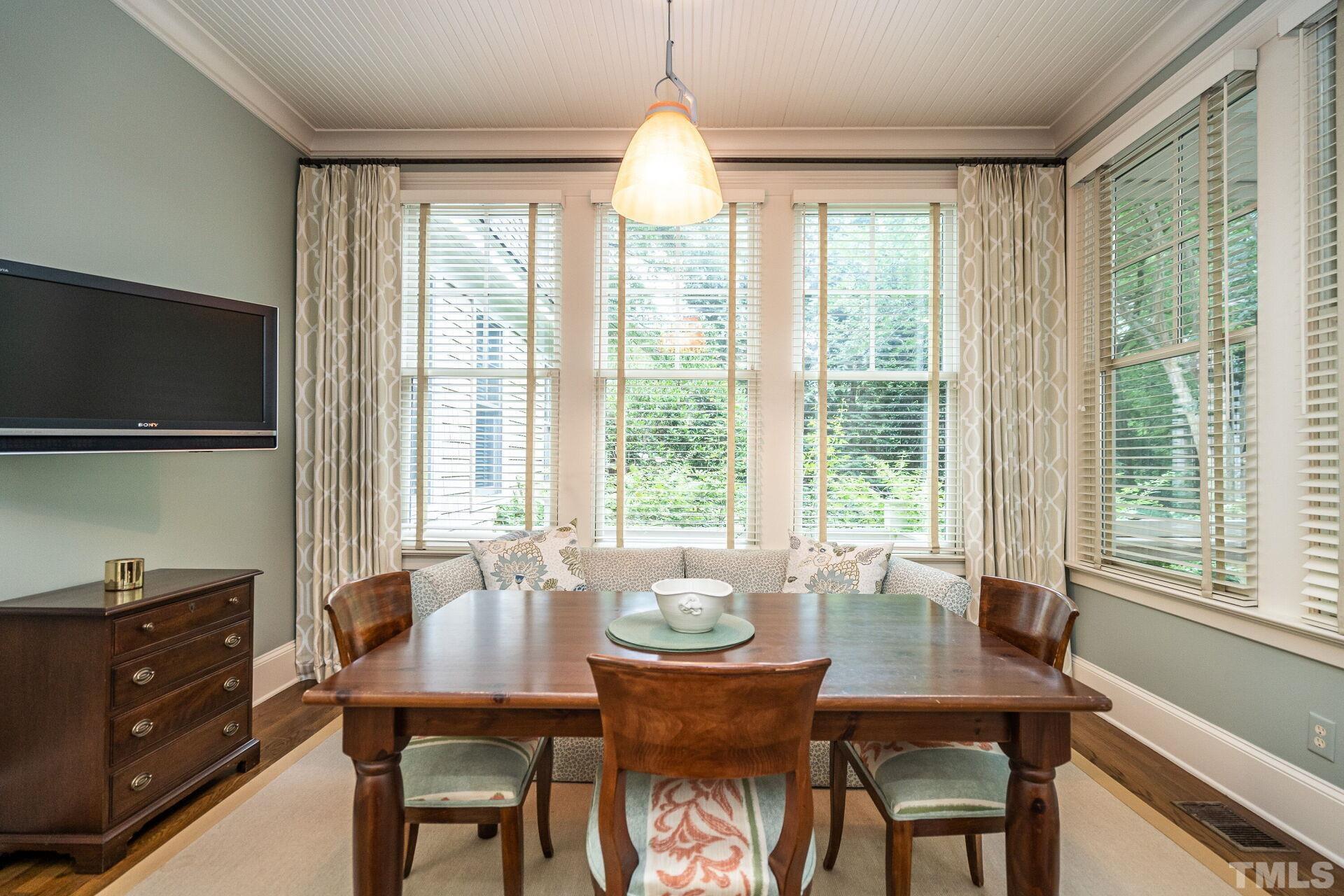 1027 Vance Street Raleigh, NC 27608 - Photo 19 of 42 a dining room with furniture window wooden floor