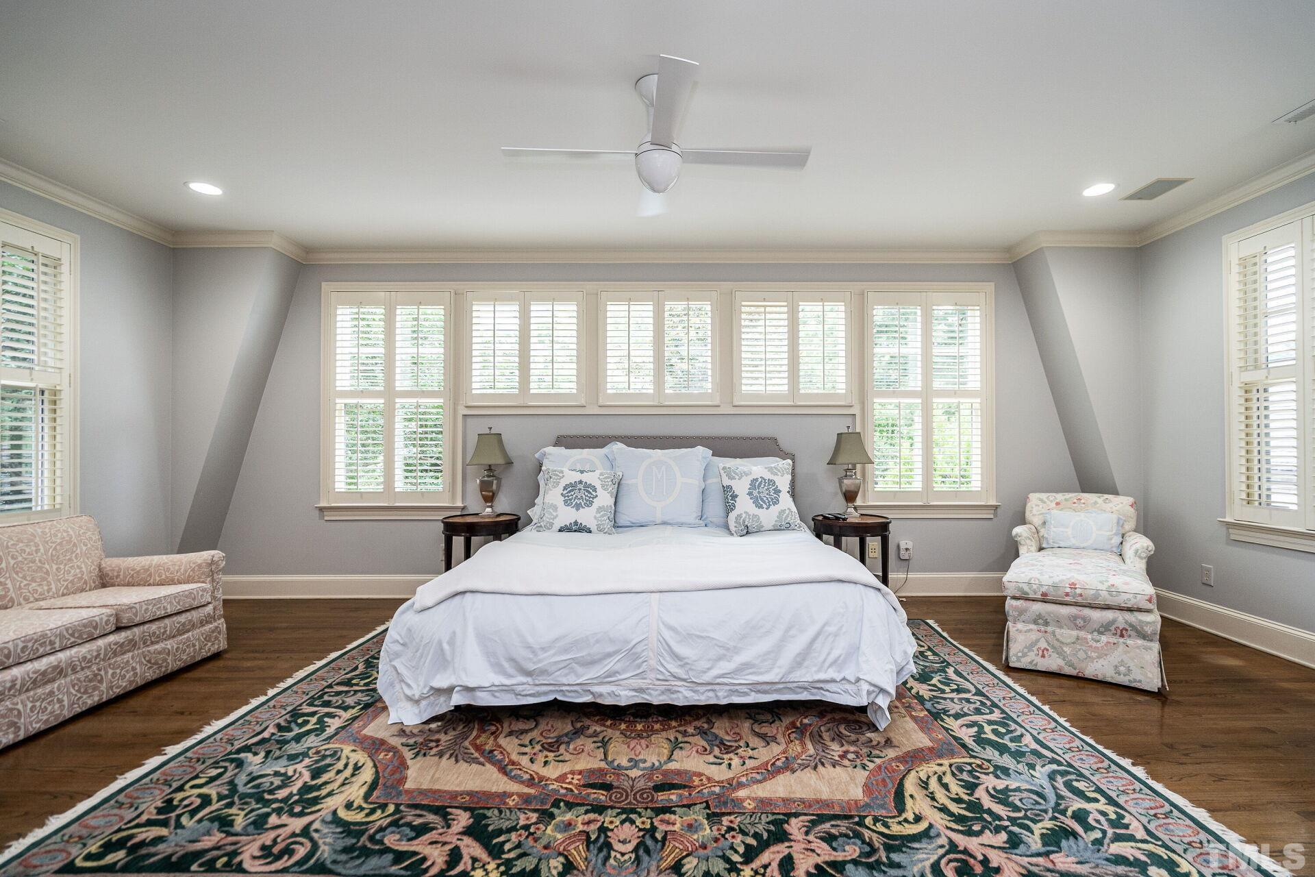 1027 Vance Street Raleigh, NC 27608 - Photo 23 of 42 a bedroom with a bed couch and windows