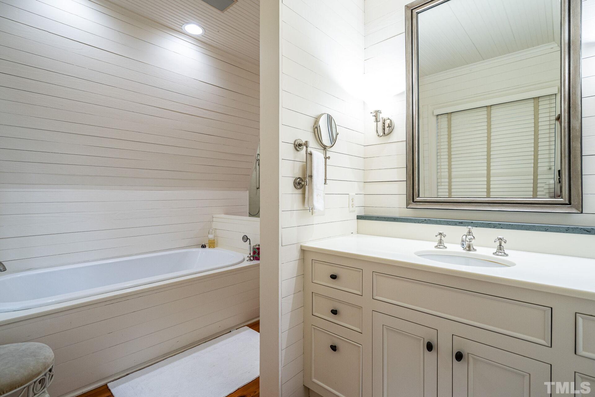 1027 Vance Street Raleigh, NC 27608 - Photo 25 of 42 a bathroom with a bathtub and a sink