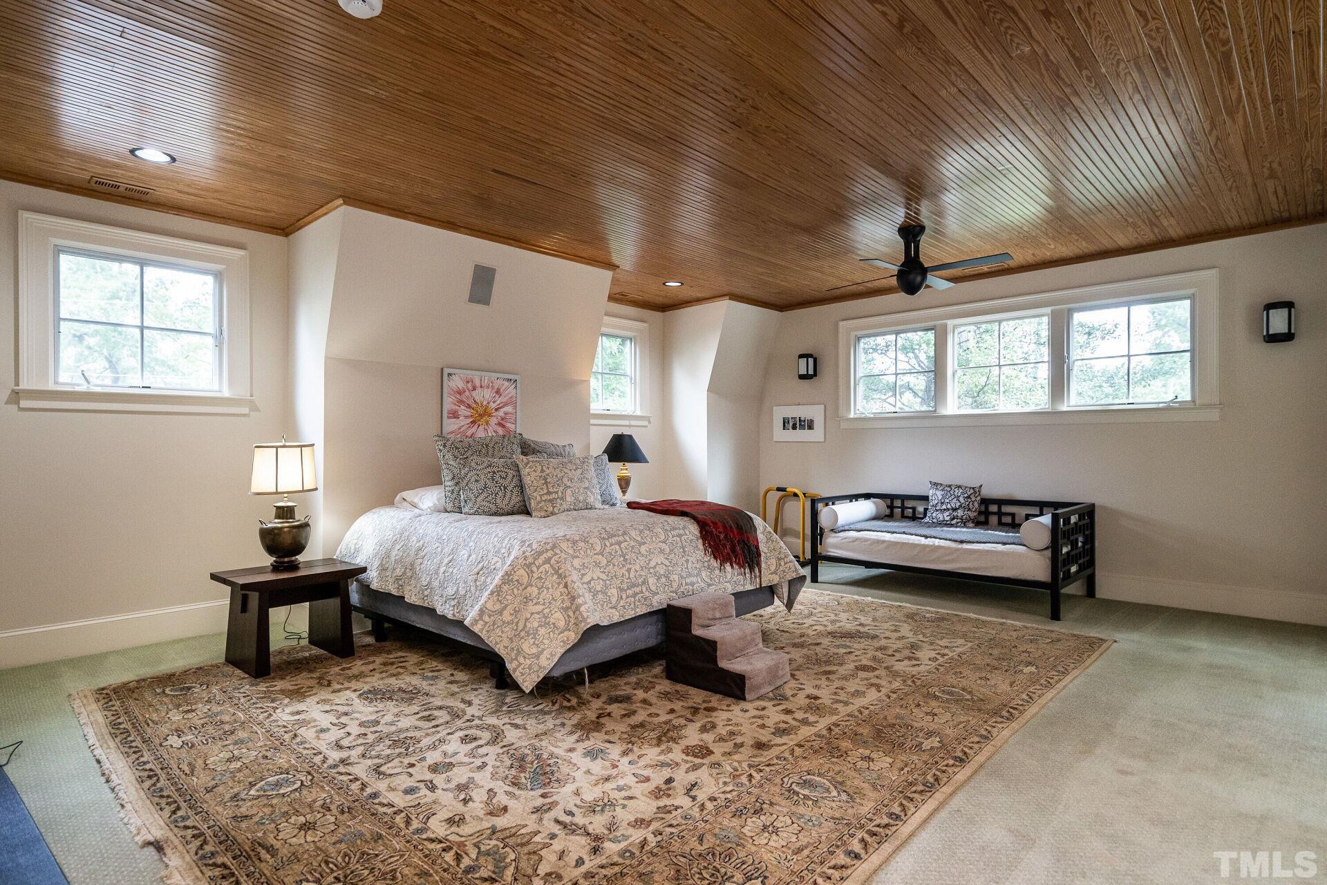 1027 Vance Street Raleigh, NC 27608 - Photo 29 of 42 a bedroom with a bed and a table