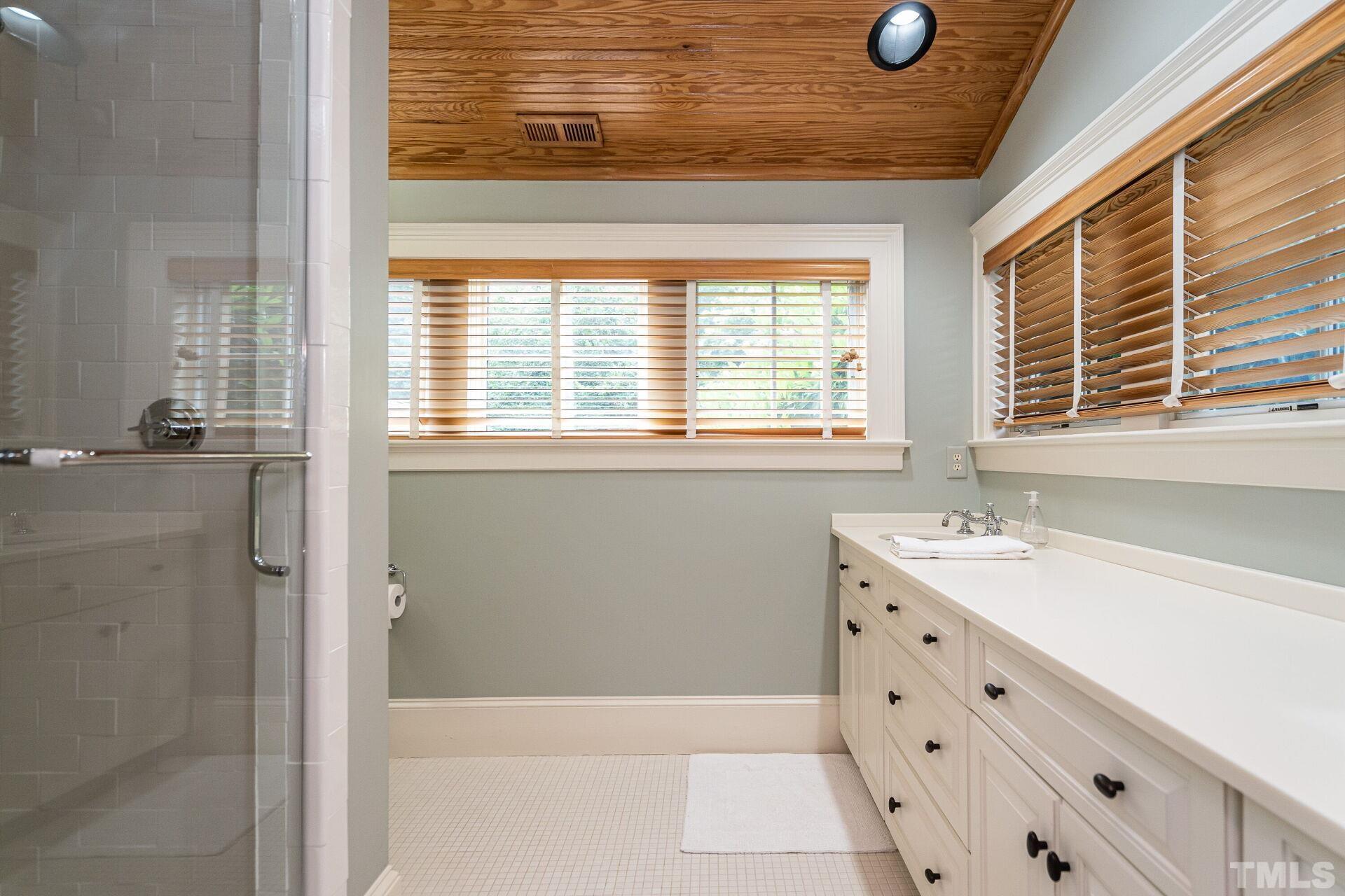 1027 Vance Street Raleigh, NC 27608 - Photo 32 of 42 a bathroom with a tub sink and window