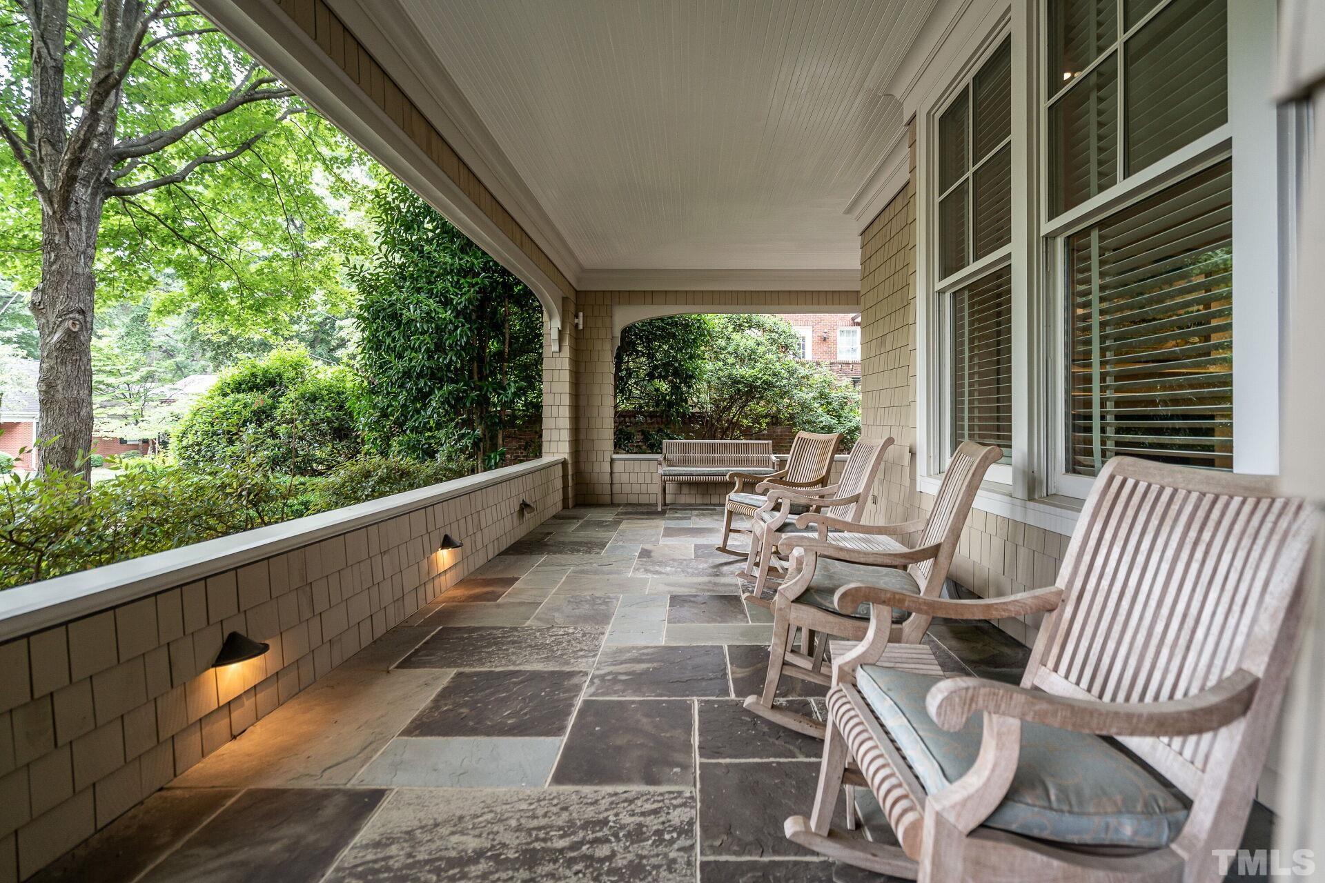 1027 Vance Street Raleigh, NC 27608 - Photo 5 of 42 a view of a patio with couches chairs potted plants and floor to ceiling window