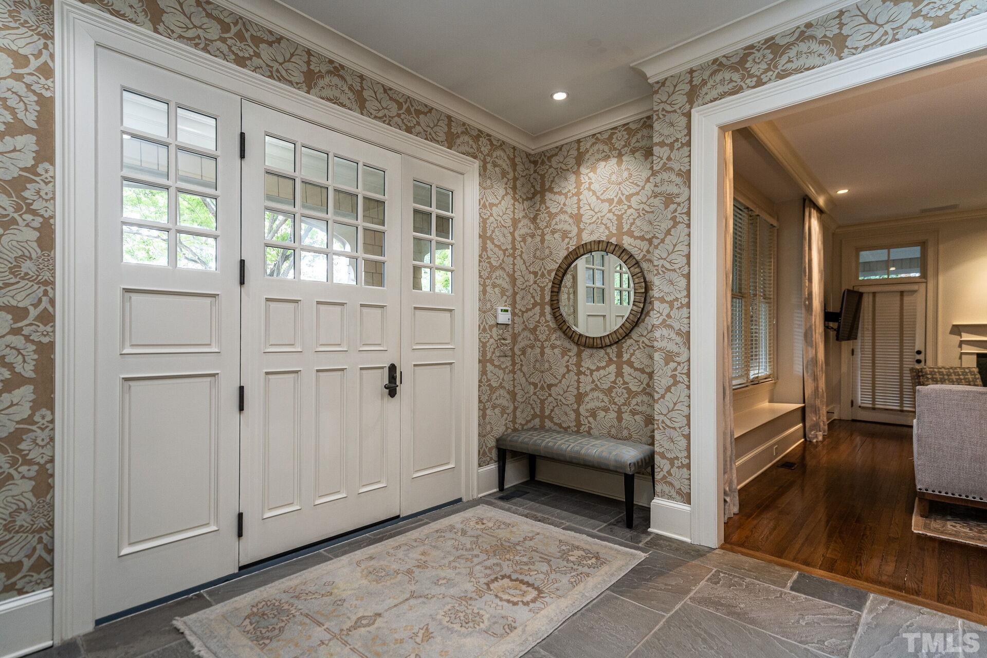 1027 Vance Street Raleigh, NC 27608 - Photo 6 of 42 a view of a hallway with entryway wooden floor and front door