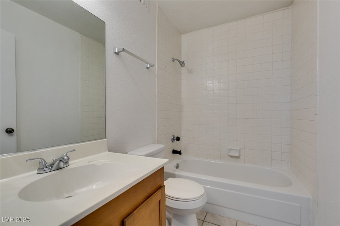 2681 Ruthe Duarte Avenue Las Vegas, NV 89121 - Photo 32 of 43 Full bathroom featuring washtub / shower combination, toilet, vanity, and tile patterned floors