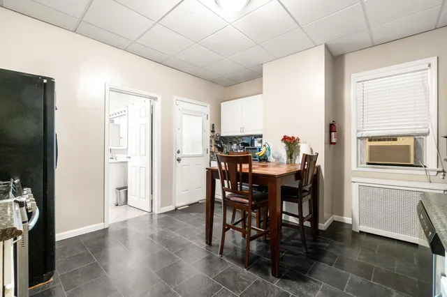 a view of a dining room with furniture and a chandelier