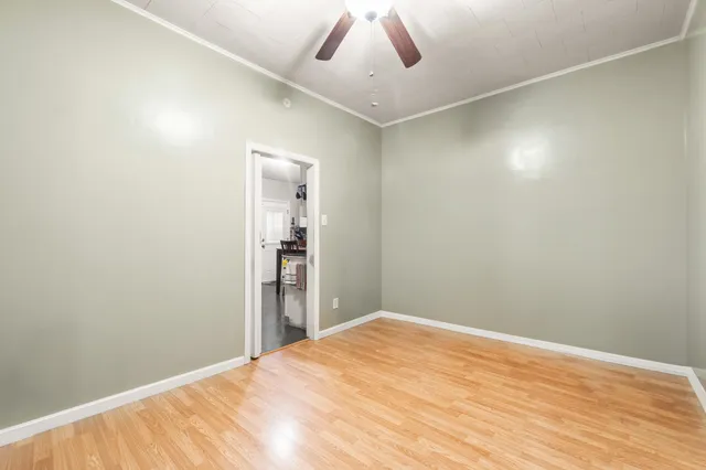 a view of empty room with wooden floor