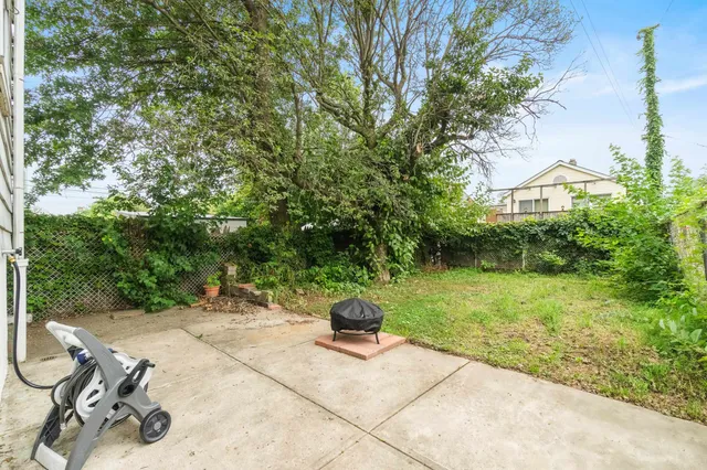 a view of a backyard with sitting area