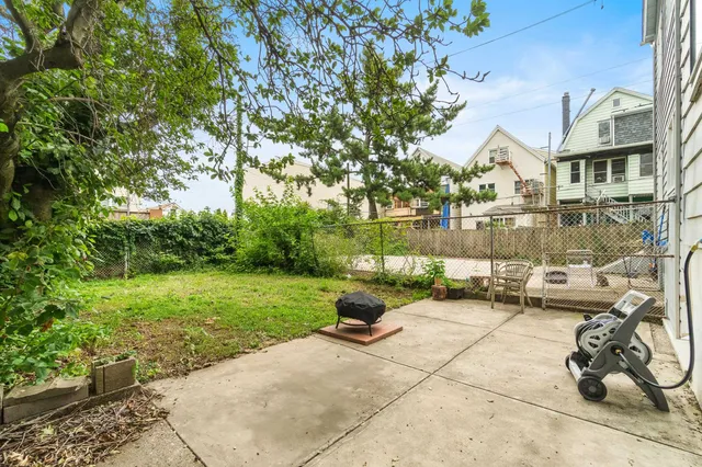 a view of a patio with a table and chairs