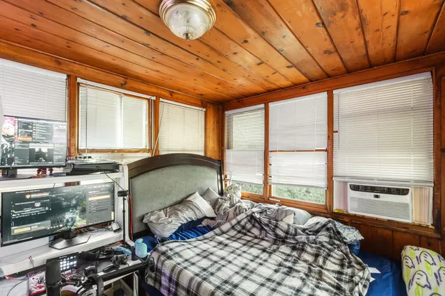 a bedroom with furniture and large window