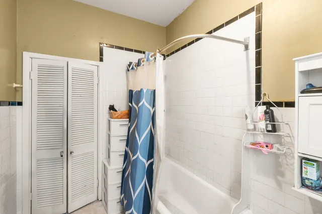 a bathroom with a tub and shower