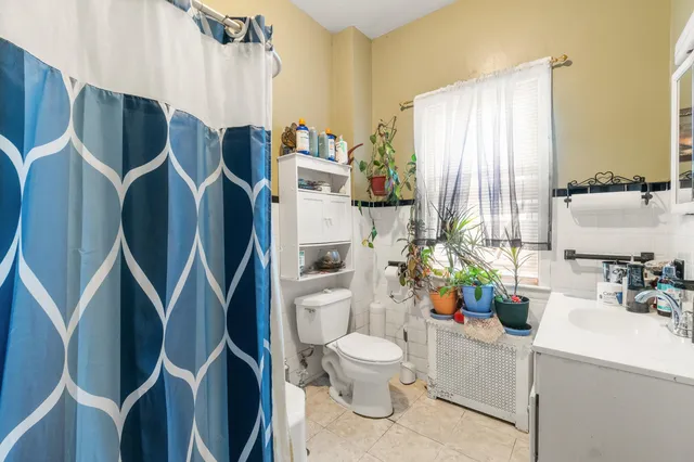 a bathroom with a sink mirror vanity and toilet