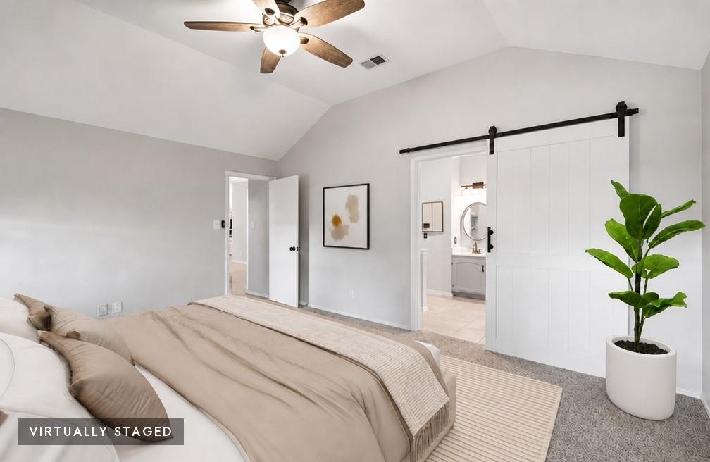 2074 Briarcliff Road Lewisville, TX 75067 - Photo 8 of 40 Vaulted ceiling room featuring a wood-finish ceiling fan with integrated lighting, a white barn door with black hardware, and carpet flooring - virtually staged