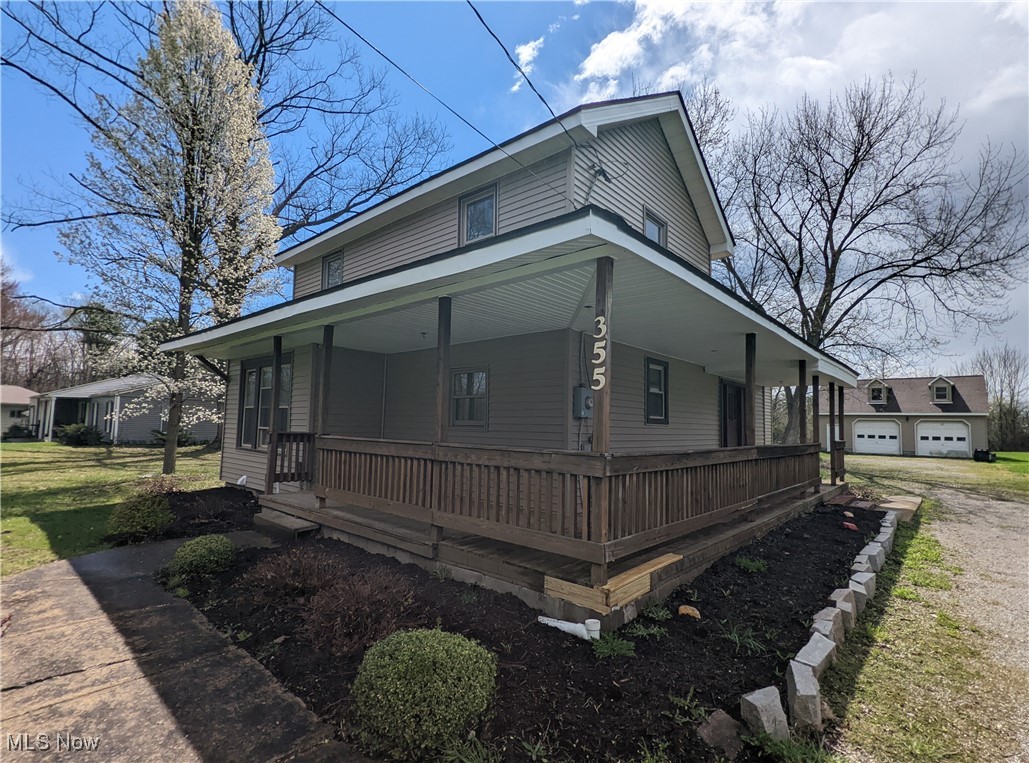 355 West Calla Road North Lima, OH 44452 - Photo 1 of 13 Farmhouse-style home featuring a porch, a front lawn, and a garage