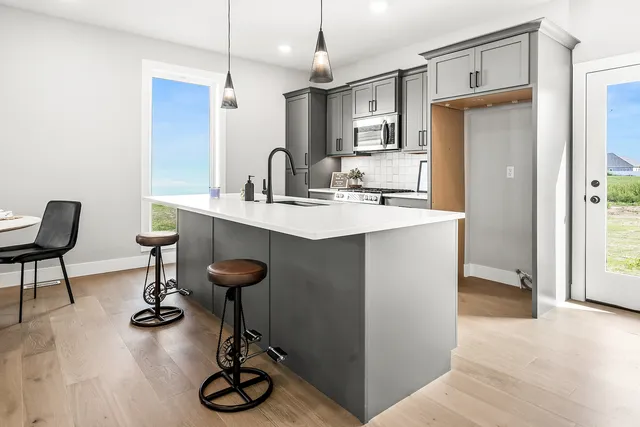 a kitchen with sink refrigerator and cabinets