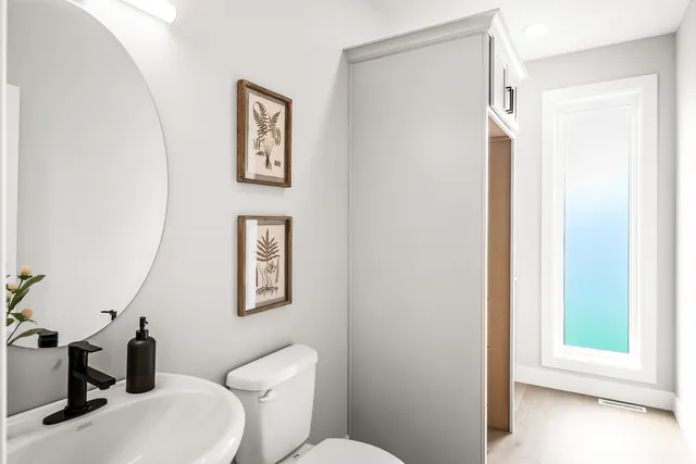 a white toilet sitting next to a bathroom sink