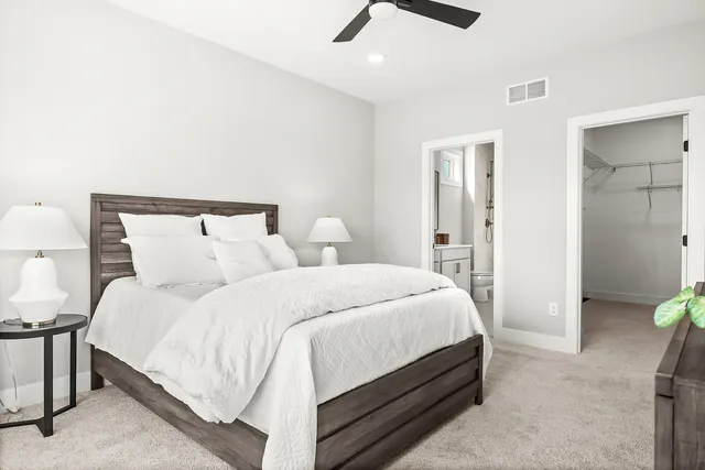 a bedroom with bed and a chandelier