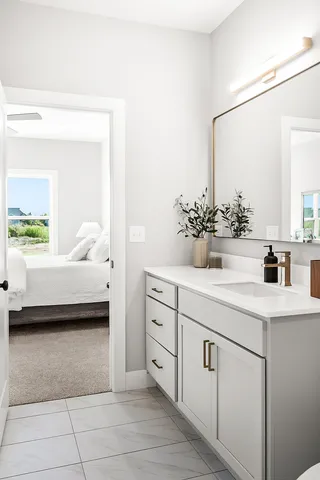 a en suite bathroom with a double vanity sink and a mirror