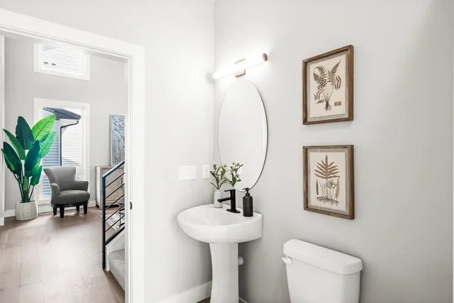 a bathroom with a toilet a sink and a mirror