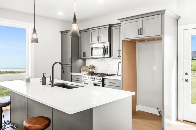 a kitchen with stainless steel appliances a sink stove and refrigerator