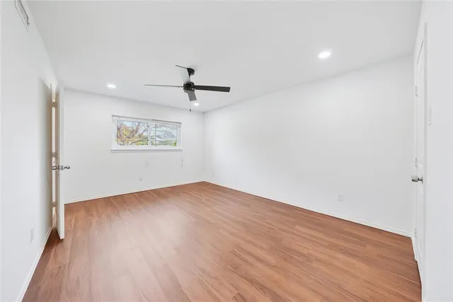 a bathroom with a toilet a sink a mirror and vanity