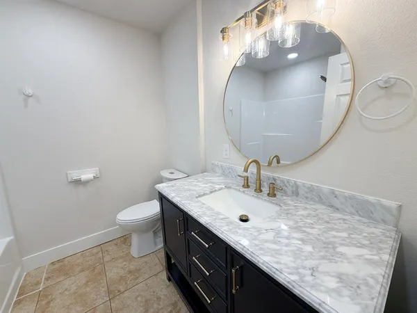a bathroom with a sink a mirror and a toilet