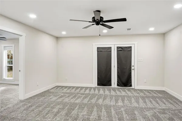 a view of a livingroom with a ceiling fan and window