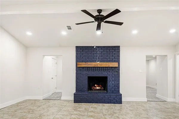 a living room with a fireplace and a fireplace
