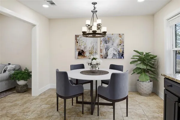 a dining room with furniture and potted plants