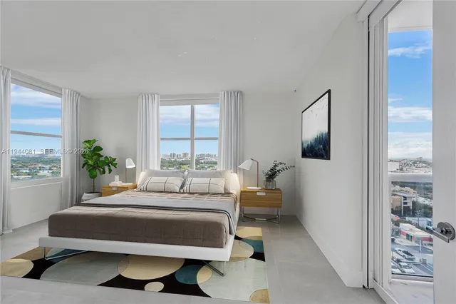 a bedroom with a bed couch and a window