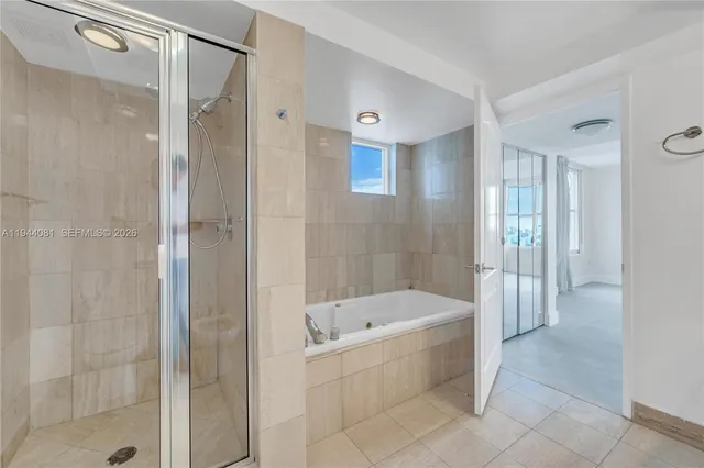 a bathroom with a bathtub and a shower