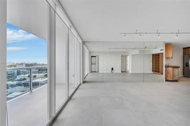 a view of an empty room with a kitchen
