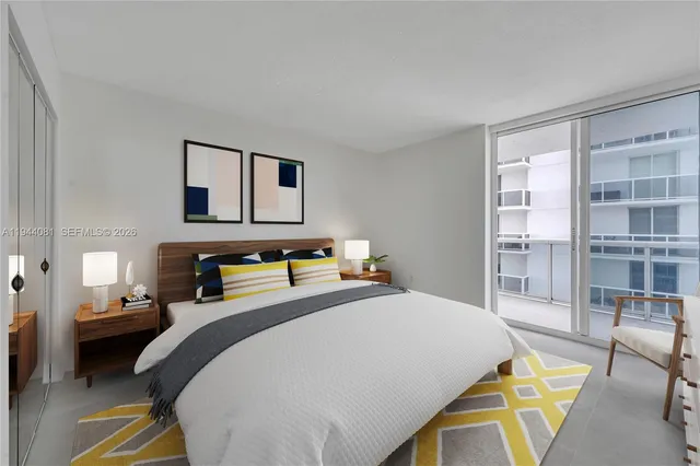 a bedroom with a bed a table and chair