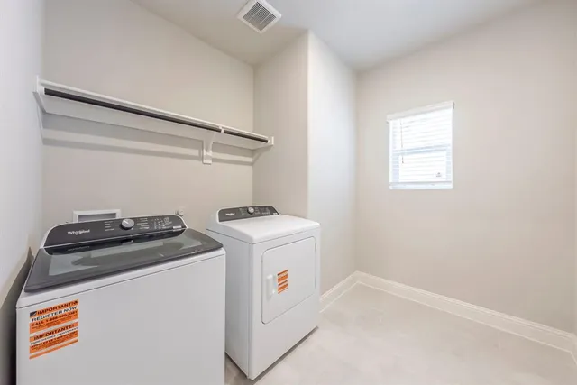 a view of a kitchen with a sink and a refrigerator