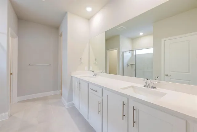 an empty room with closet and a chandelier fan