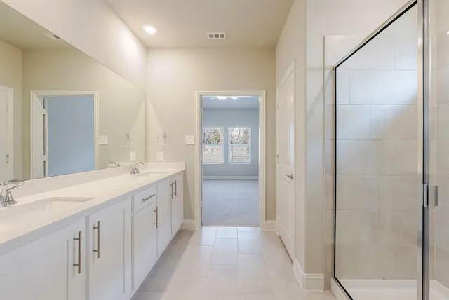 a bathroom with double sink and a mirror