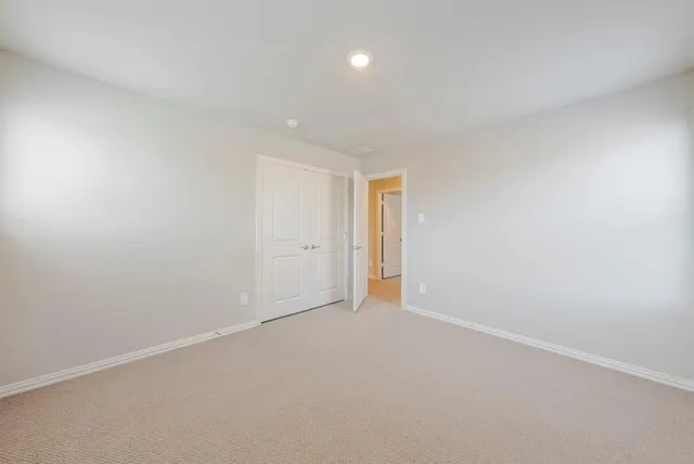 an empty room with windows and entrance