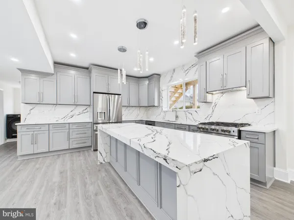 a kitchen with stainless steel appliances granite countertop a stove oven and white cabinets