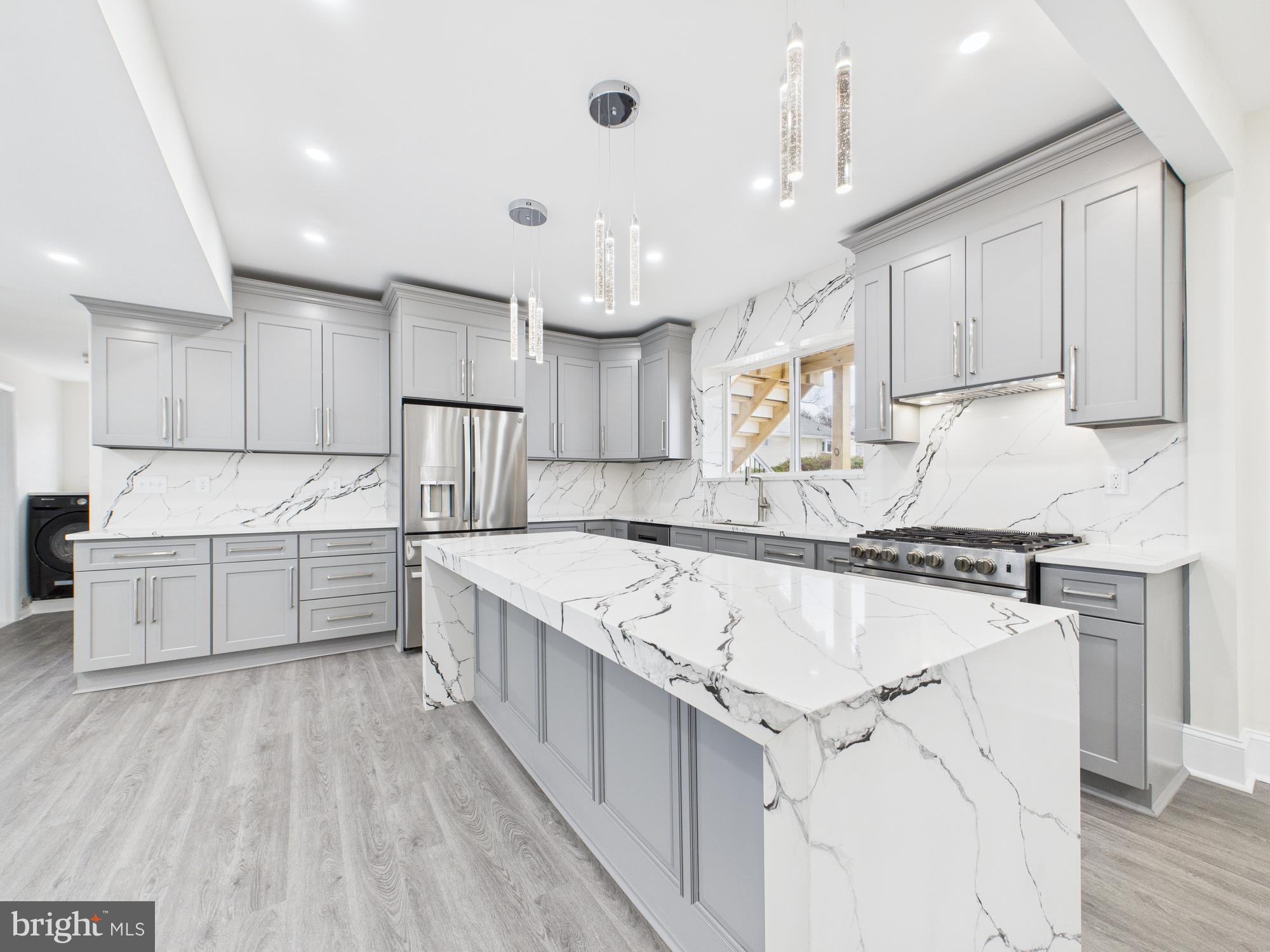 a kitchen with stainless steel appliances granite countertop a stove oven and white cabinets