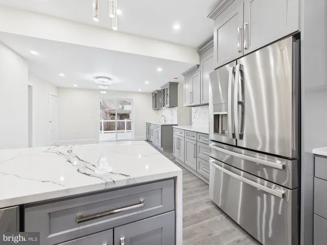 a kitchen with kitchen island a sink appliances and cabinets