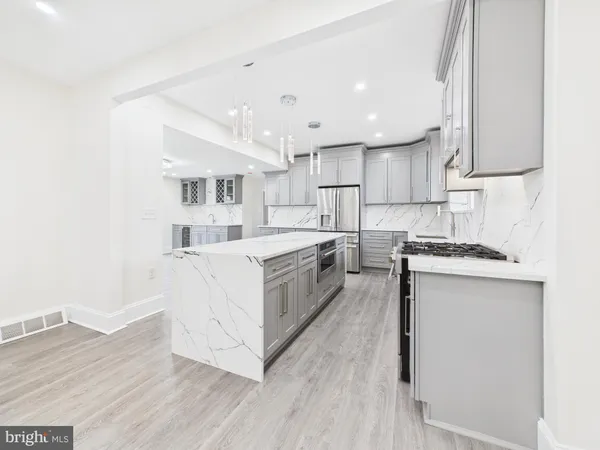 a kitchen with white cabinets and white appliances