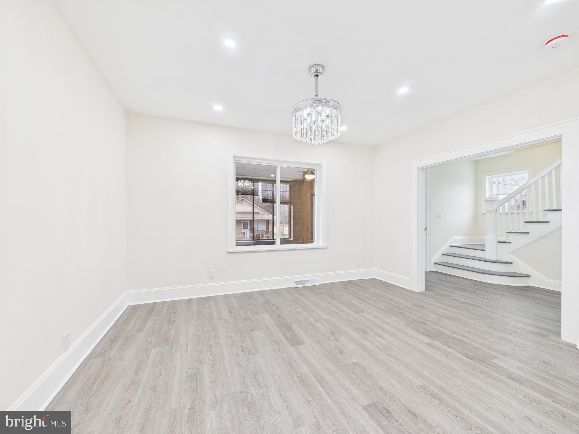 820 East Oldtown Road Cumberland, MD 21502 - Photo 13 of 40 an empty room with wooden floor and windows
