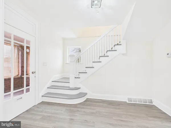 a view of entryway and hall with wooden floor